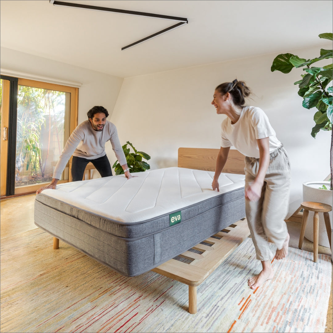 Couple placing Eva Mattress on to Eva Timber Bed Frame | {"option1":["Comfort Classic Mattress"]}